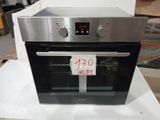 a silver oven sitting on top of a white table