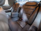 a seat in the back of a car with a remote control