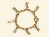a close up of a gold bracelet with charms on it