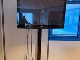 un téléviseur à écran plat posé sur un support dans une pièce