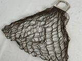 a net bag with a handle on a white surface