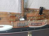 a model of a boat on display in a glass case