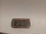 a silver plate and a silver knife on a table
