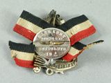 a silver medal with a red, white, and blue ribbon around it