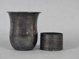 two vases sitting next to each other on a table