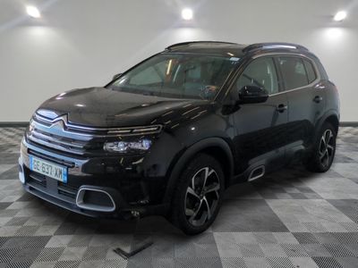 the black citrole is parked on a checkered tile floor