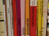 a lot of books that are sitting on a shelf