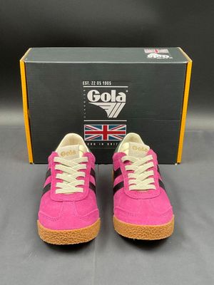 a pair of pink and black sneakers with a box in the background