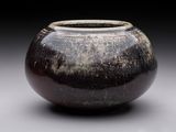 a black and white vase sitting on a table