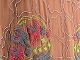 an image of a woman ' s dress with beads and beads on it