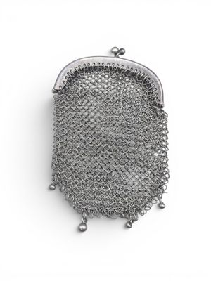 a close up of a metal mesh purse on a white surface
