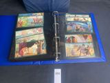 a blue binder with pictures of people and animals on it