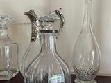three glass vases sitting on a table next to each other
