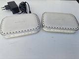 two wireless devices that are sitting on a table