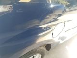 a close up of a car ' s front bumper with a hole in it
