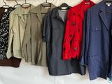 a lot of coats hanging on a clothes rack