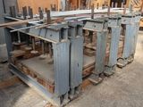de nombreuses pièces métalliques empilées sur des palettes dans un entrepôt