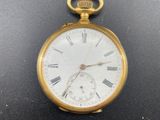 a gold pocket watch with roman numerals on it