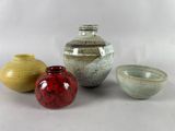 three small vases sitting next to each other on a table