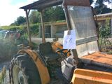 a tractor that is parked in the dirt