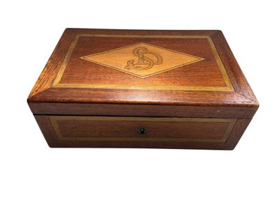 une image représentant une boîte en bois sur laquelle figure un monogramme