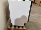 a white refrigerator sitting on a pallet in a warehouse