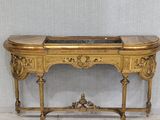 a gold colored table with a marble top