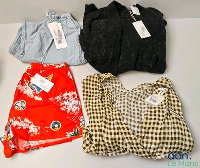 three pairs of shirts and a bag on a table