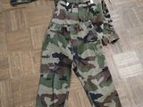 a camouflage suit laying on the floor on the floor