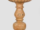 an old wooden pedestal with a bowl on top of it
