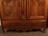 a wooden armoire with a mirror on top of it