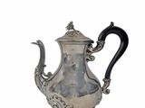an antique silver teapot with a black handle on a white background