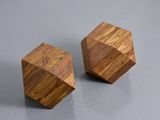 two wooden cubes sitting on a gray surface