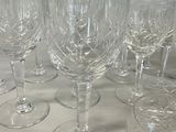 many empty wine glasses lined up on a table