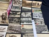 a lot of old postcards that are on a table