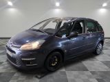 a picture of a small blue car parked in a garage