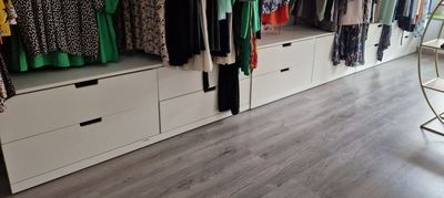 a closet with a lot of clothes on the shelves
