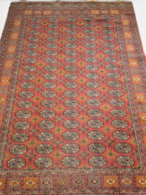 a red rug with medallions and medallions on a white background