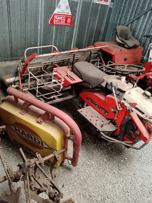 a red and yellow motorcycle parked next to a red and yellow moped