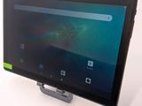 the tablet is sitting on top of the stand on the table