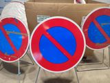 a lot of signs that are sitting on a stand