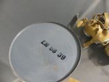 a silver pan with a yellow ribbon on it next to a cup of coffee