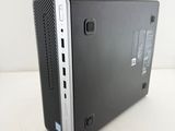 the back of a small black computer sitting on top of a white table