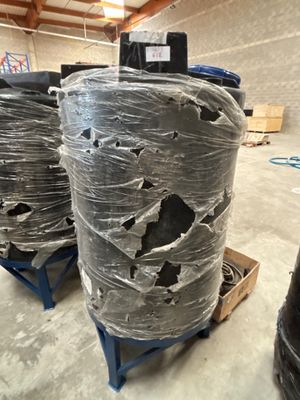 many rolls of plastic wrapped up on a pallet in a warehouse