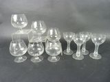 a lot of wine glasses that are sitting on a table