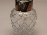 a glass jar with a metal lid on a table