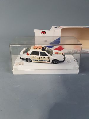a toy police car in a display case on a table