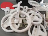 a pile of wii remote controls and controllers on a table