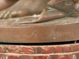 a bronze statue of a dog on a pedestal