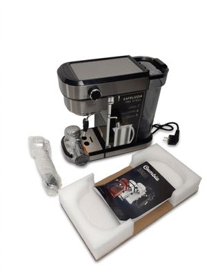 a coffee machine that is sitting next to a book